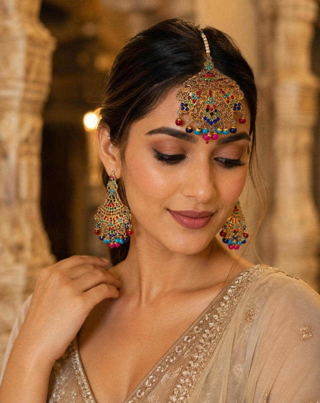 Multicolor Kundan-style maang tikka and earring set styled on model
