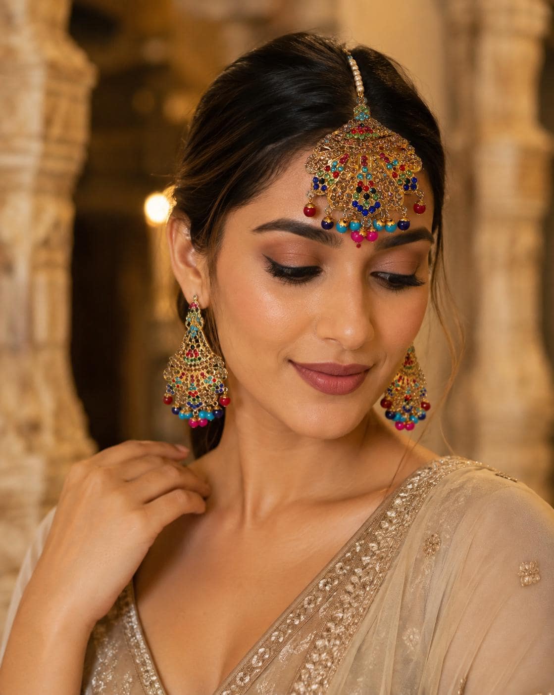 Multicolor Kundan-style maang tikka and earring set styled on model