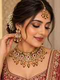 Gold-tone Kundan bridal choker set with earrings and maang tikka