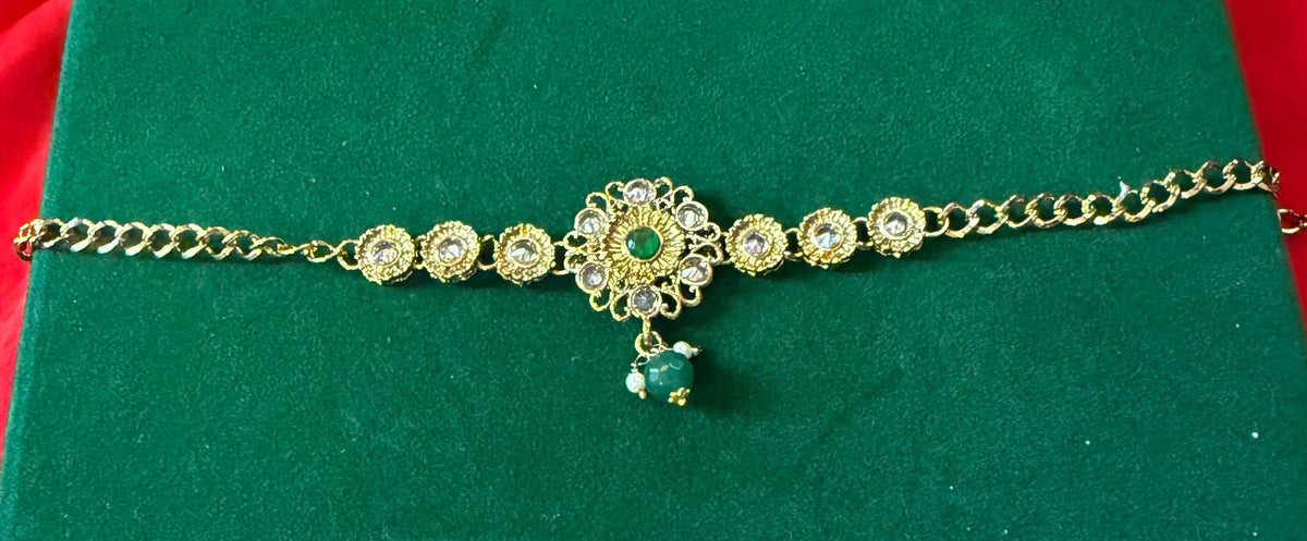 Gold-tone green stone bracelet – floral centerpiece and green drop detail